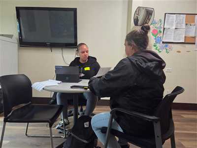 Legacy case manager meeting with a client at a table